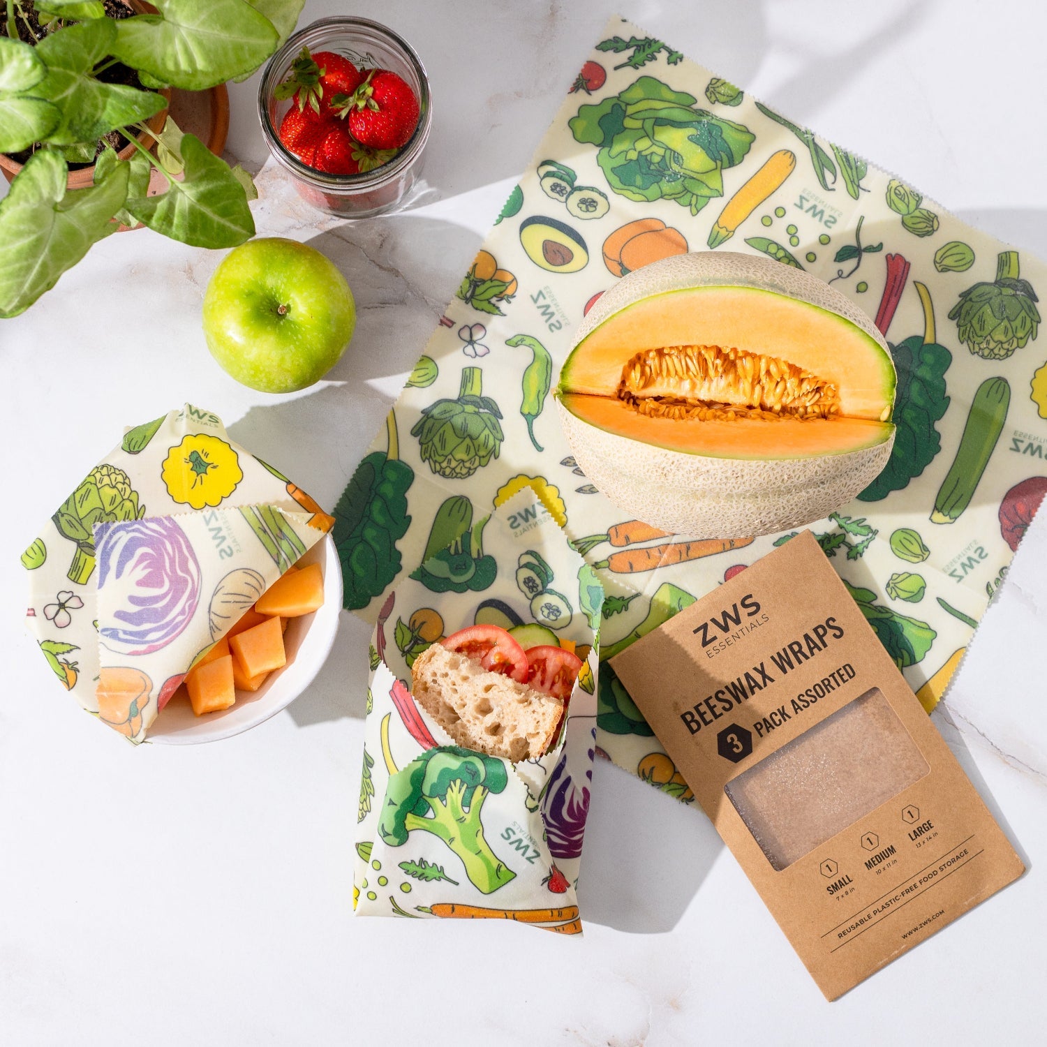ZWS beeswax wraps with food items on a white surface
