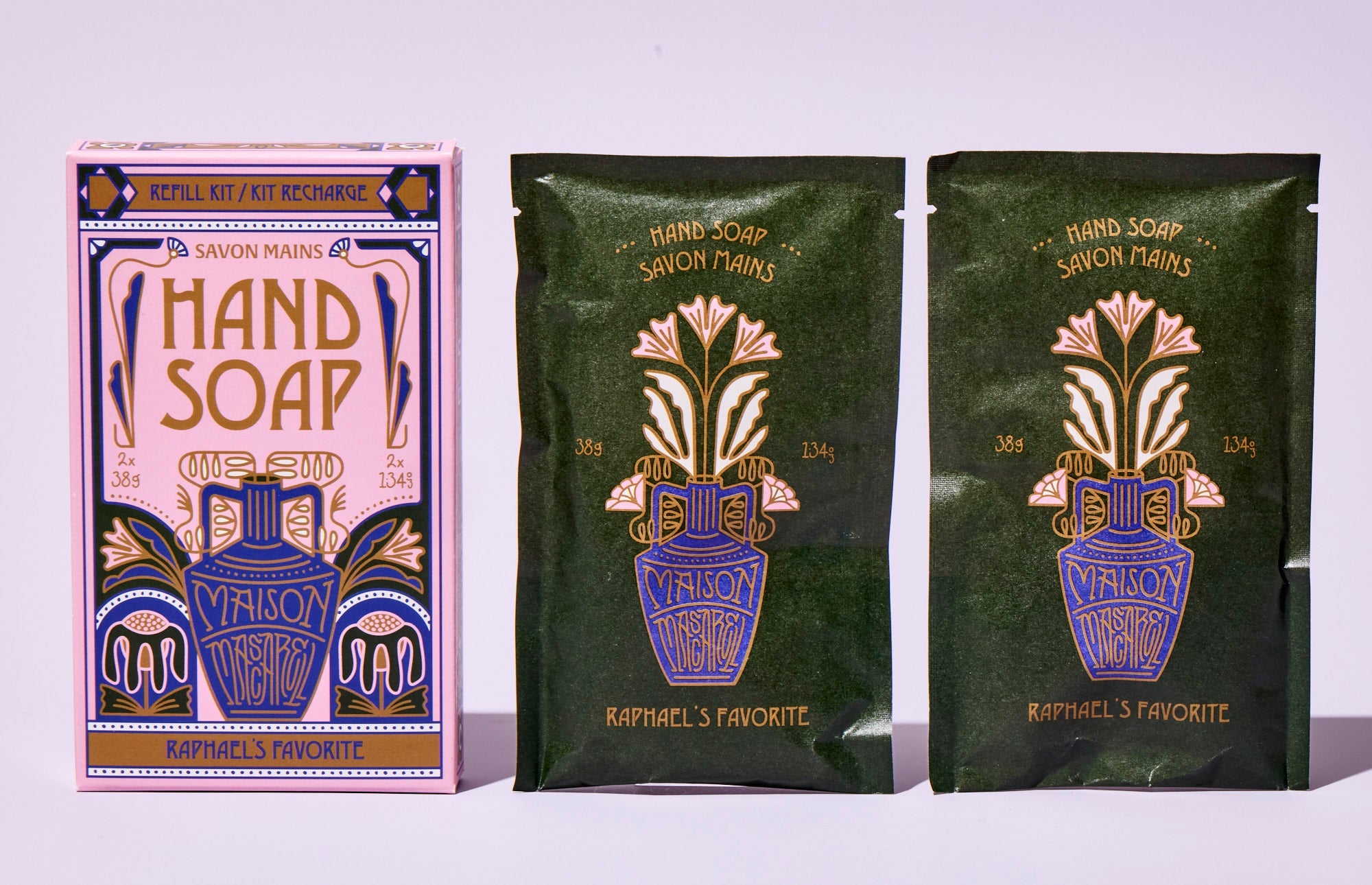 Three packages of 'Hand Soap' with decorative designs on a light purple background