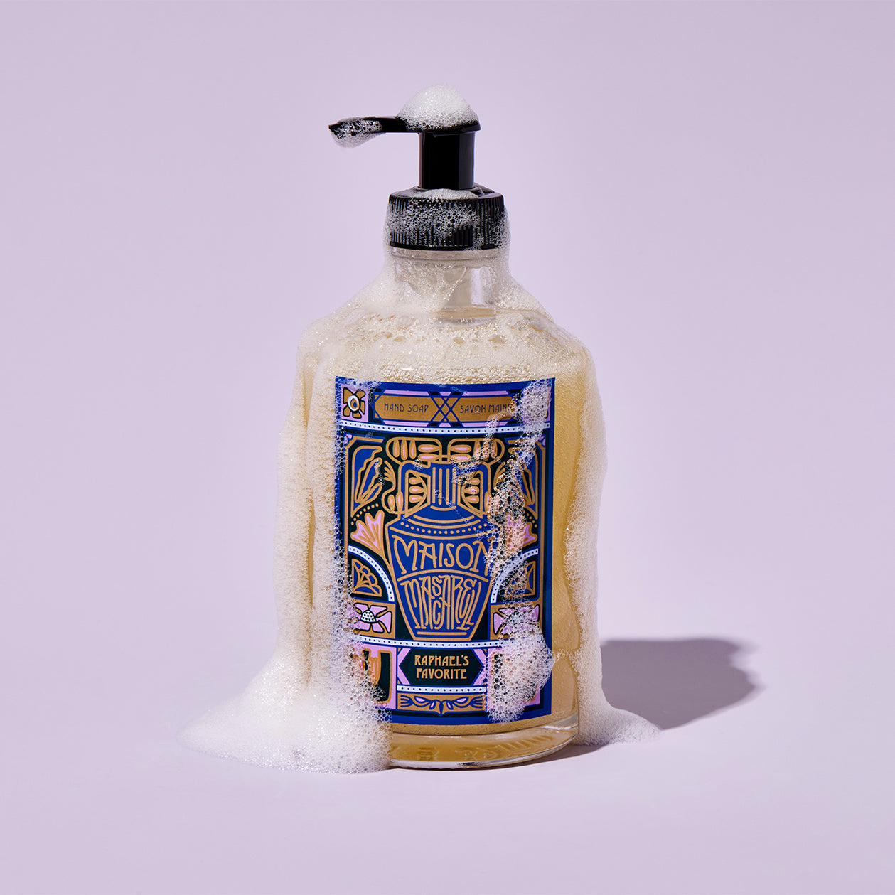 Bottle of soap with a decorative label on a light purple background