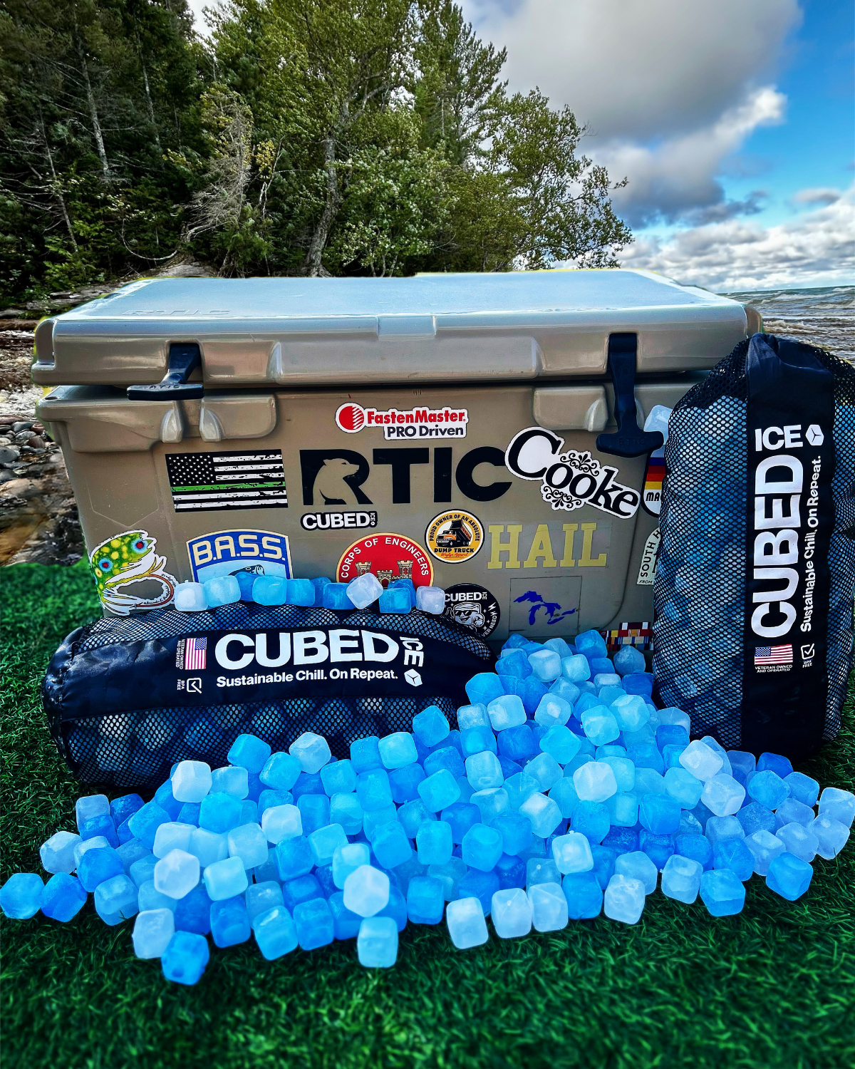 RTIC cooler with Cubed ice and promotional stickers by a lake.