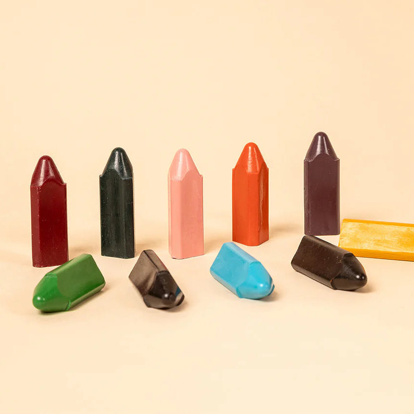 Colorful crayon-like objects on a beige background