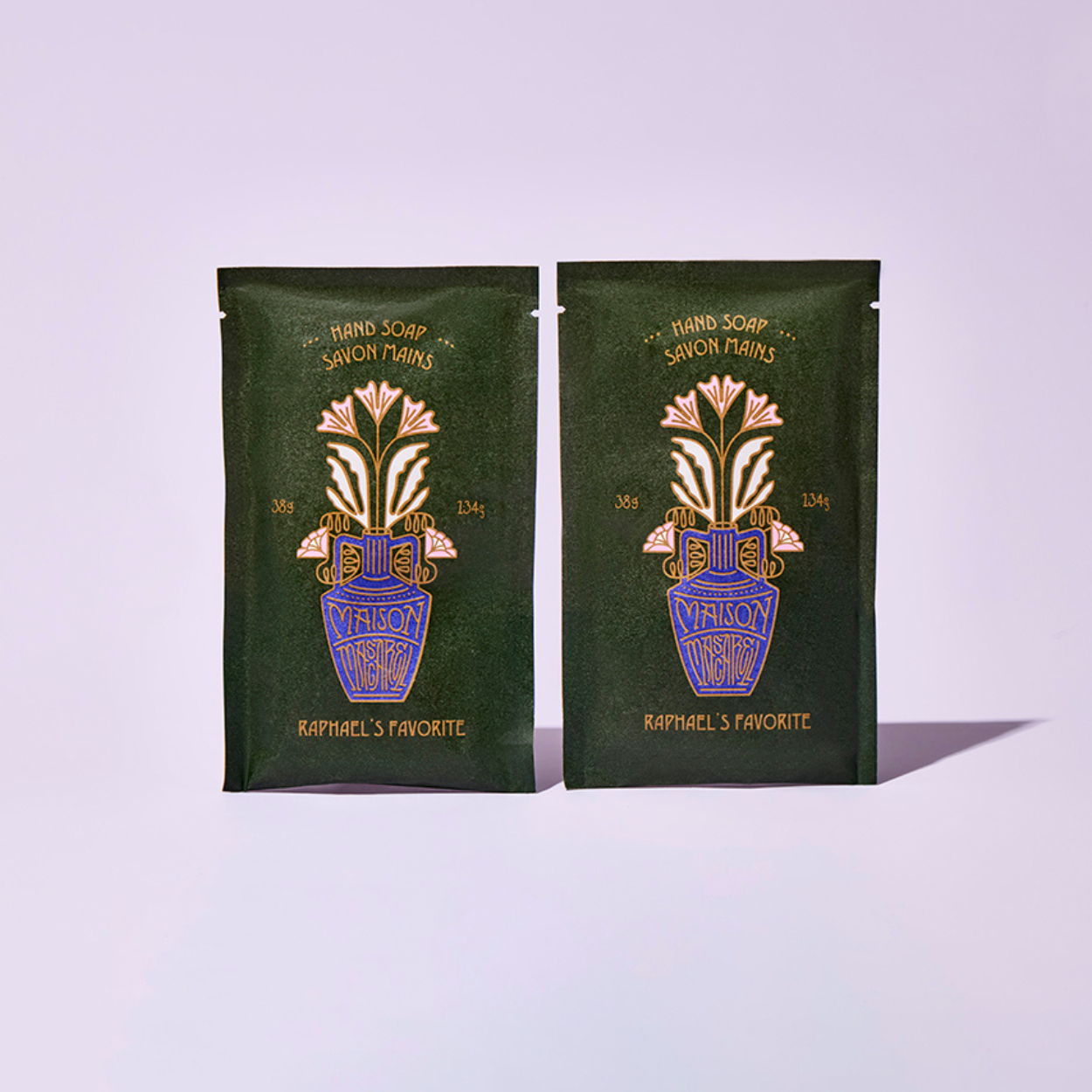 Two green packages with floral design and text on a light purple background