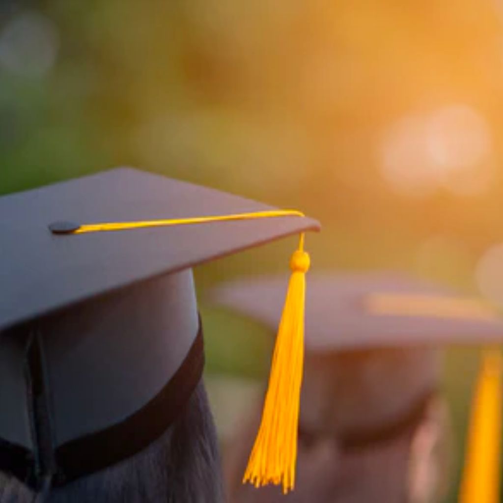 Two people wearing graduation caps