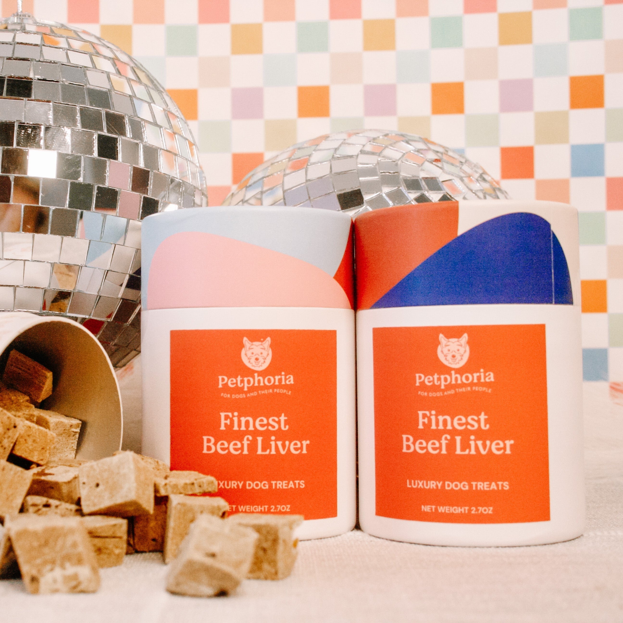 Petfood containers with dog treats on a colorful checkered background