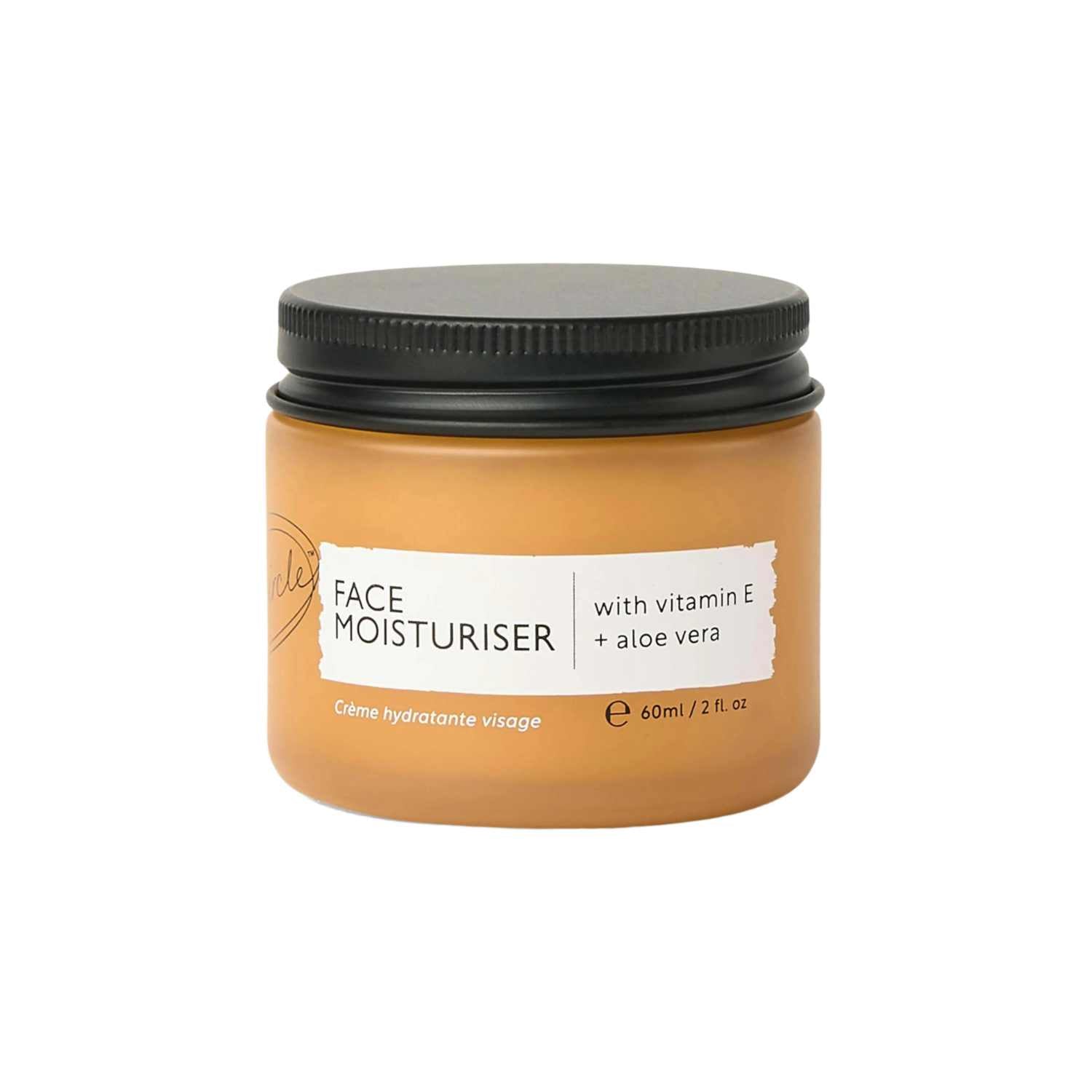 Jar of face moisturizer with black lid on a white background